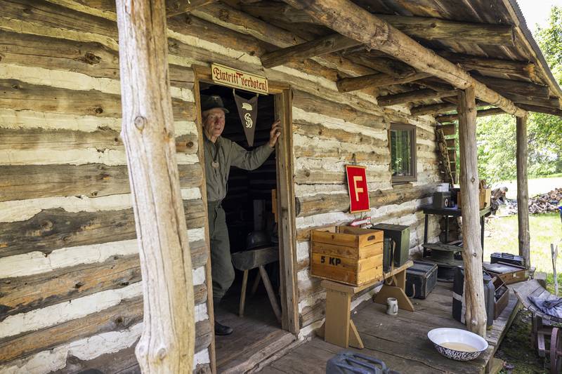Stephen Wendorf displays items in a replica German field headquarters Saturday, May 16, 2026, at Franklin Grove’s Chaplin Creek. The historic village was transformed into an Italian hamlet during the reenactment of the Battle of Anzio.