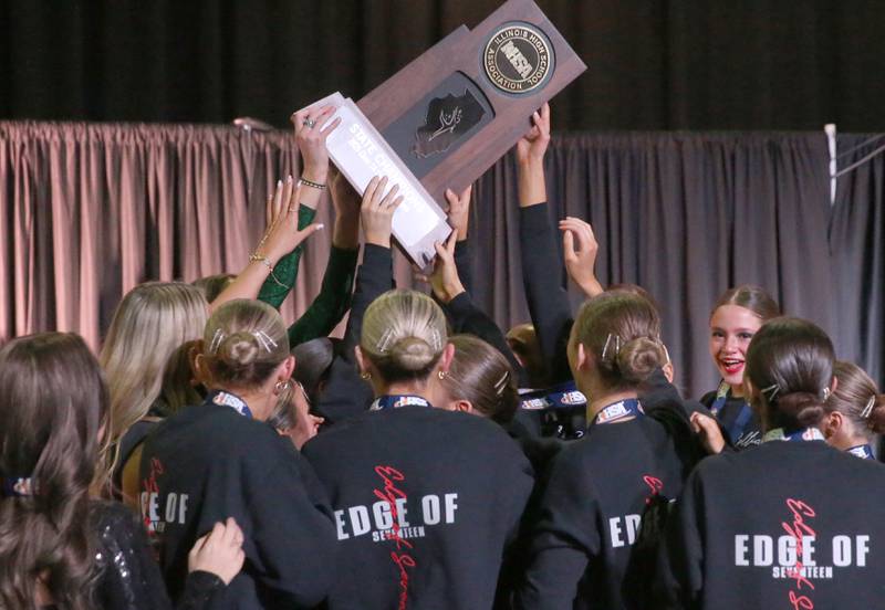 Members of the Providence Catholic dance team hold the Class 1A HSA State Dance trophy on Saturday, Feb. 1, 2025 at Grossingers Motor Arena in Bloomington.