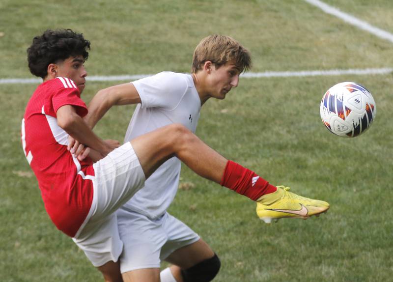 Dundee-Crown's Alex Beltran tries to kick the ball away from Crystal Lake South's Nolan Getzinger during a Fox Valley Conference soccer match Tuesday, Sept. 5, 2023, at Dundee-Crown High School in Carpentersville.