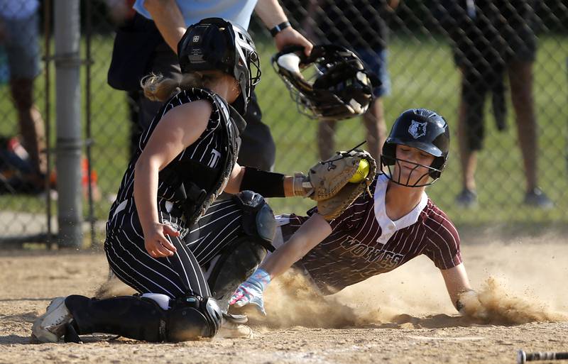 Prairie Ridge's Kylie Carroll (left) slides into home plated in front of the tag of Crystal Lake Central's Cassidy Murphy to score Prairie Ridge’s second run during a Fox Valley Conference softball game on Wednesday, May 14, 2025, at Crystal Lake Central High School.