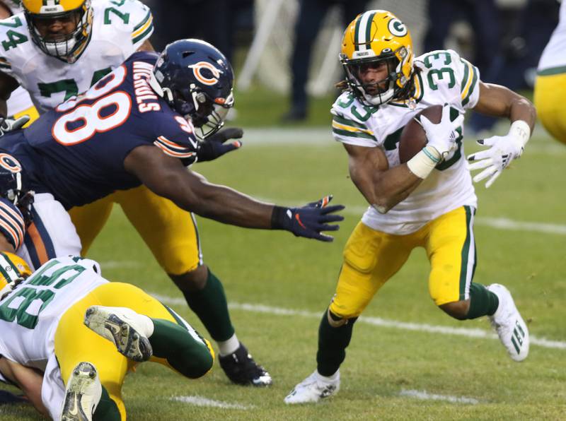 Chicago Bears nose tackle Bilal Nichols (98) reaches to grab Green Bay Packers running back Aaron Jones (33) during their game Sunday at Soldier Field in Chicago.