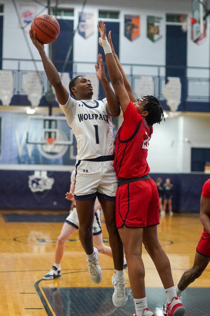 Oswego East's Andrew Wiggins (1) shoots the ball in he post over West Aurora's Evan Hackney (23) during a basketball game at Oswego High School on Friday, Feb 2, 2024.