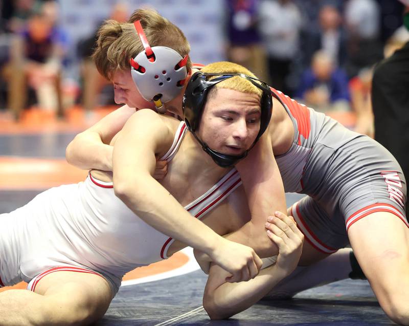 Ottawa’s Ivan Munoz (bottom) wrestles Morton’s Harrison Dea in the Class 2A 106 pound 5th place match in the IHSA individual state wrestling finals in the State Farm Center at the University of Illinois in Champaign.