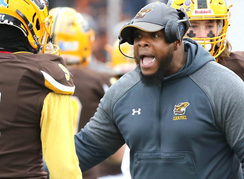 Carmel head coach Jason McKee talks to a player during their Class 5A second round playoff game against Sycamore Saturday, Nov. 5, 2022, at Carmel Catholic High School in Mundelein.