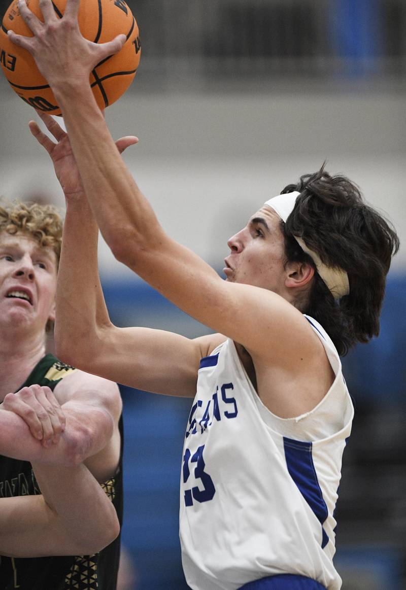 St. Francis’ Dylan Ston drives against St. Edward in a boys basketball game in Wheaton on Tuesday, December 6, 2022.