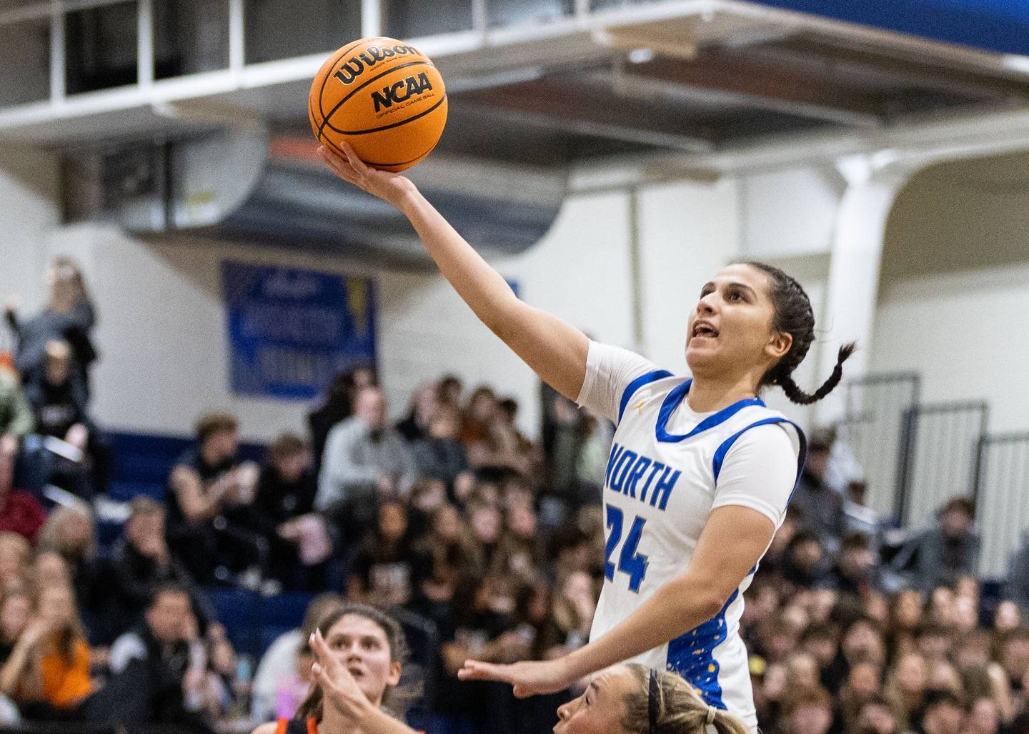 Wheaton North’s Sara Abdul goes up for a layup during a game against Wheaton Warrenville South at Wheaton North High School on Friday, Dec. 20, 2024.