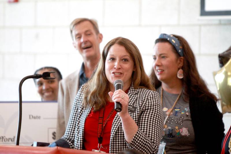 Angie Behm, enrichment administrator at Bolingbrook High School, says a few words about teacher Erin Clifford. Clifford was surprised by her family, colleagues, students and Golden Apple Foundation officials on Tuesday, May 6, 2025 as it was announced she had won a Golden Apple Award for Excellence in Teaching.