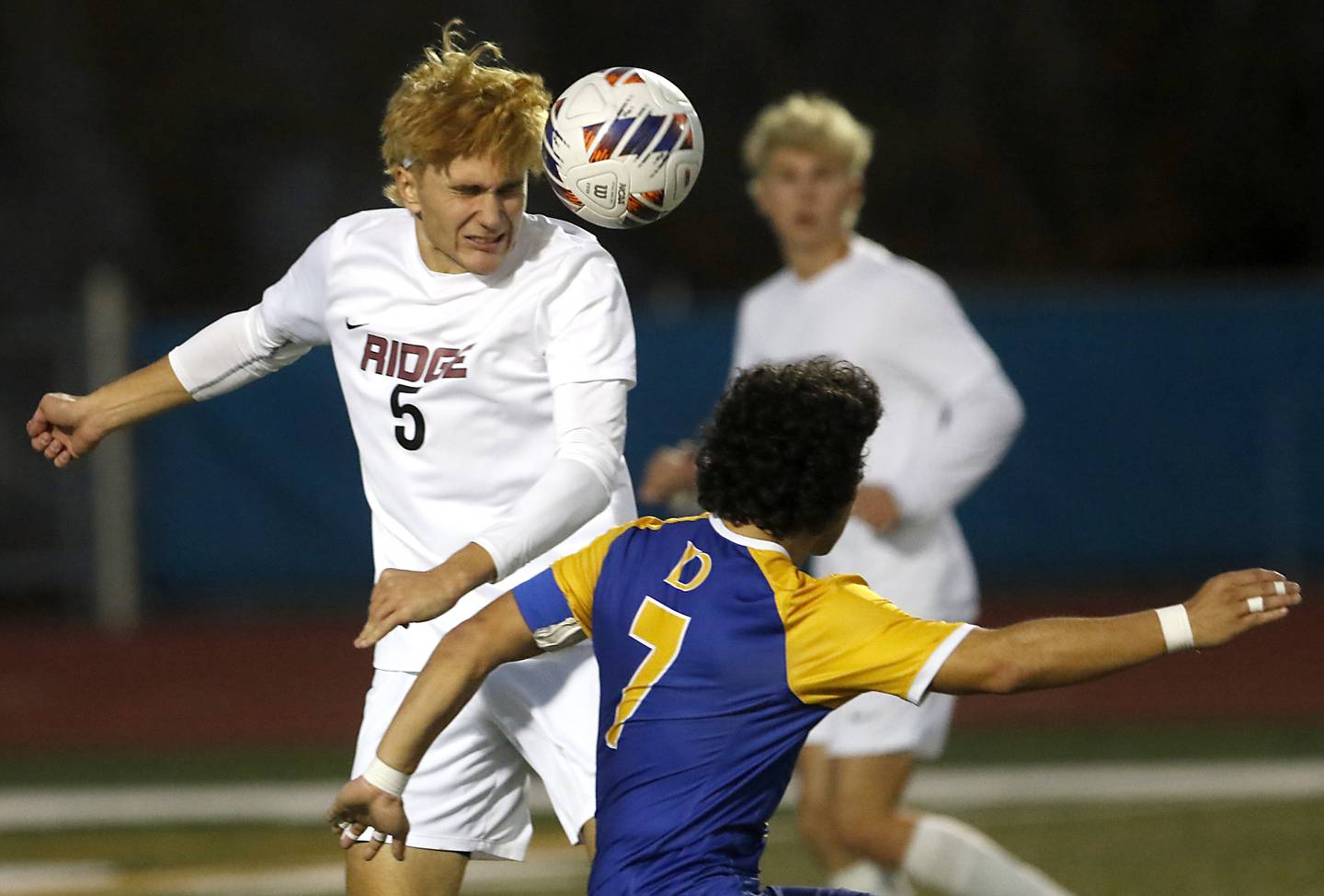 Prairie Ridge's Brandon Matei heads rh ball away from Chicago De La Salle's Agustin Ortega during an IHSA Class 2A state semifinal soccer match on Friday, Nov. 8, 2024, at Hoffman Estates High School.