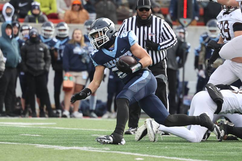 Nazareth’s Anthony Donato surges ahead for extra yards on a run against Joliet Catholic in the Class 5A state championship on Saturday, Nov. 30, 2024 in Normal.