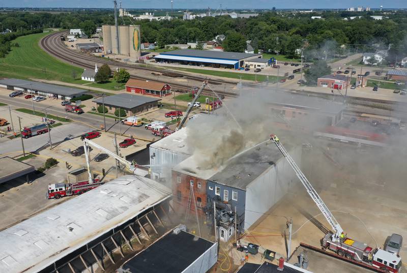 Firefighters use aerial trucks to extinguish flames from an apartment fire in the 800 block of Main Street on Monday, Aug. 22, 2022 in Mendoa.