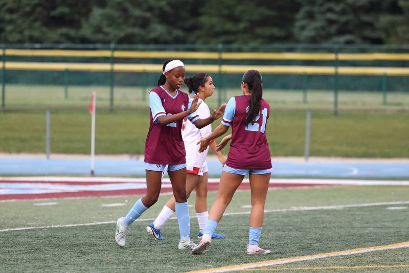 Kankakee's Alina Mkhwanazi, left,  is congratulated after her goal by teammate Jocelyn Sanchez during the Kays' 5-0 win against Blue Island Eisenhower in the Class 2A Kankakee Regional semifinals on Tuesday, May 19, 2026.