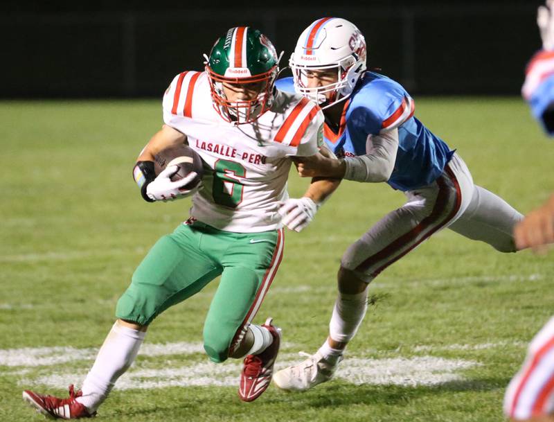 L-P's Adrian Arzola runs with the ball as he is brought down from behind by Ottawa's Joey Leibhart on Friday, Oct. 4, 2024 at King Field.