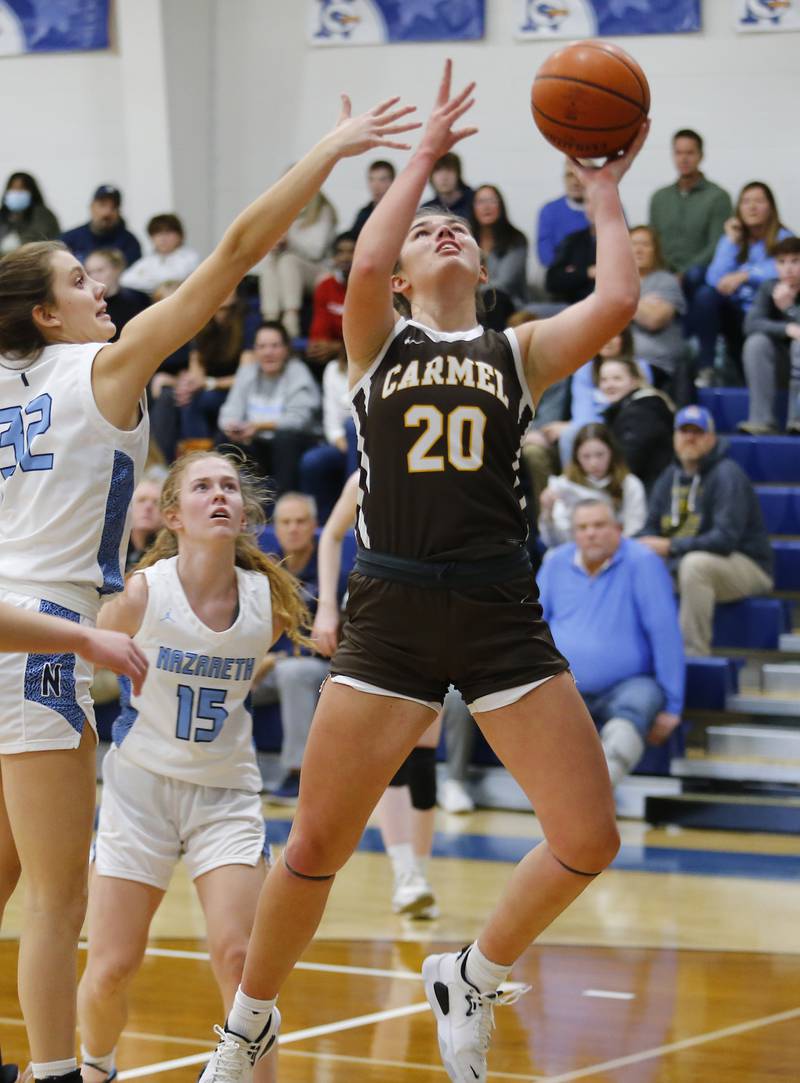 Carmel's Mia Gillis (20) puts up a shot during the girls varsity basketball game between Carmel High School and Nazareth Academy on Wednesday, Dec. 7, 2022 in LaGrange, IL.