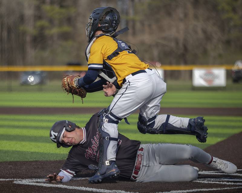Moline’s Tanner Soucinek is tagged out by Sterling’s Nick Capp Wednesday, April 16, 2025.