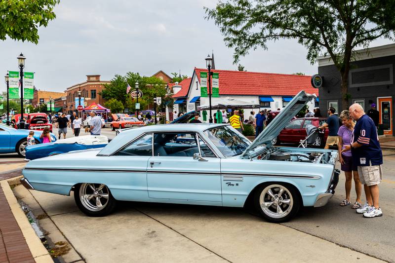 Attendees enjoy checking out the classic cars on Lockport Street during the first Plainfield Cruise Night of the season on June 3, 2025.