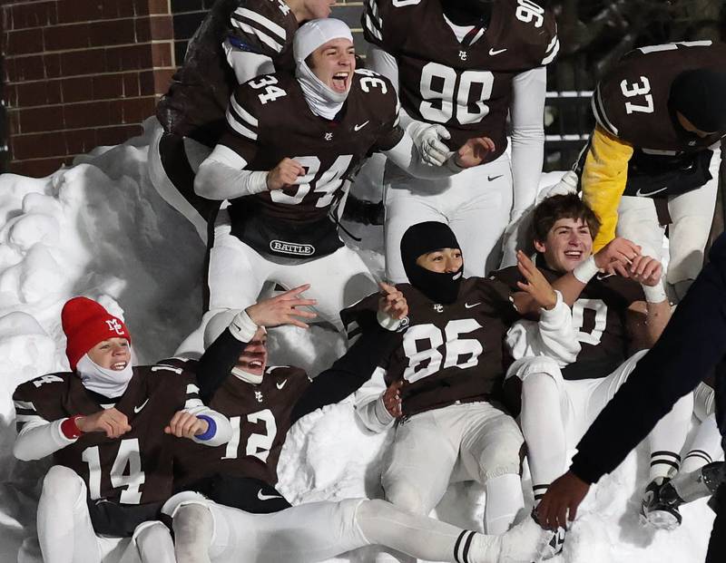 Mount Carmel players celebrate in the snow Wednesday, Dec. 3, 2025, after their win over Oswego in the IHSA Class 8A state chamionship game in Huskie Stadium at Northern Illinois University in DeKalb.