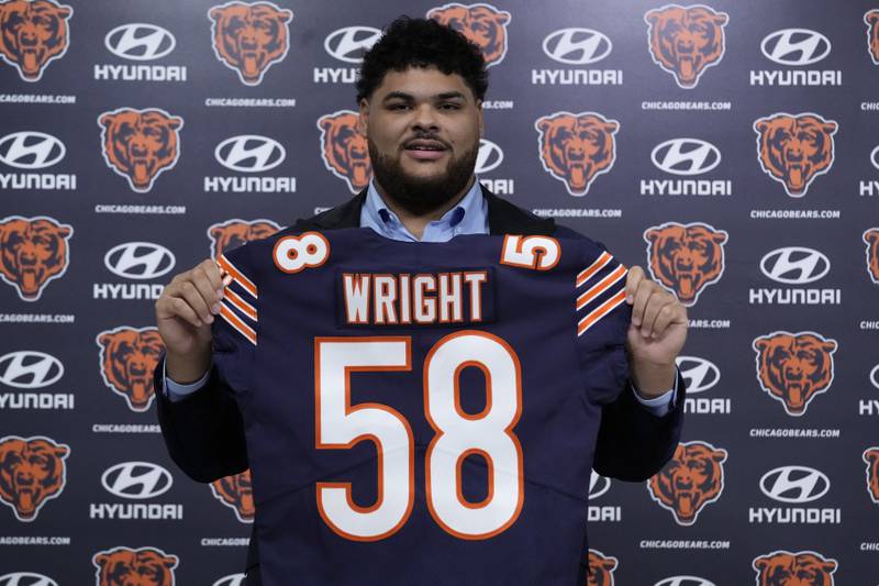 Chicago Bears first-round draft pick offensive lineman Darnell Wright poses with his jersey, Friday, April 28, 2023, at Halas Hall in Lake Forest.
