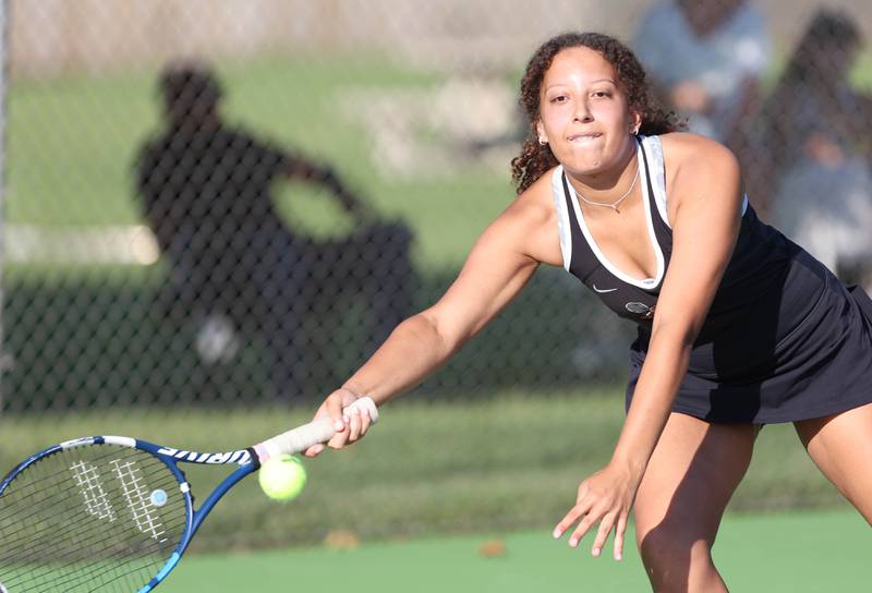 DeKalb's Amirah Shakir lunges for a forehand during her doubles match against Sycamore Monday, September 19, 2022, at Sycamore High School.