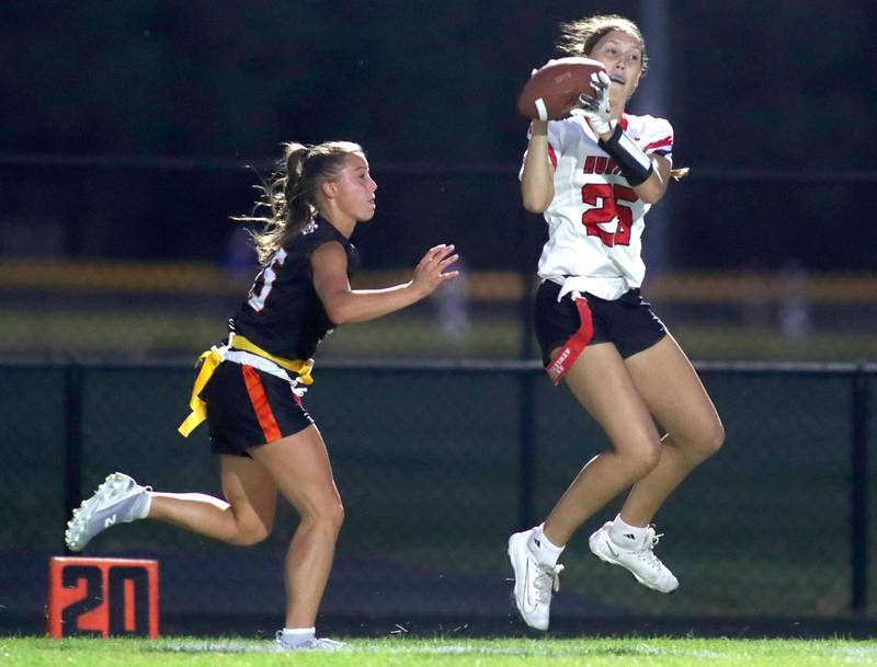 Huntley’s Evelyn Freundt, right, reels in a touchdown pass ahead of Crystal Lake Central’s  Emma Sieg in varsity flag football at Owen Metcalf Field on the campus of Crystal Lake Central High School in Crystal Lake on Tuesday, Sept. 16, 2025.
