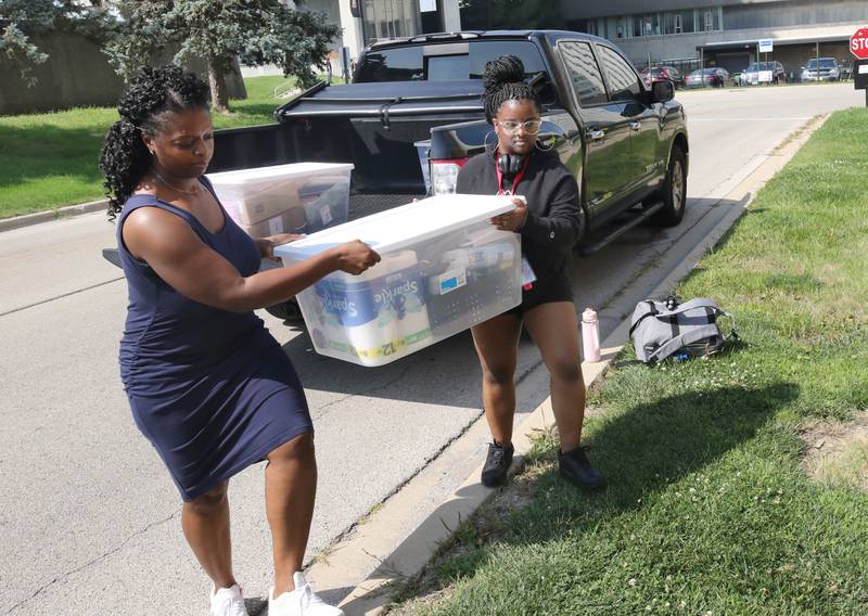 Northern Illinois University freshman Serenity Stewart, (right) from Plainfield, gets a hand from her mom Michelle Gillespie as they unload things to move into her room Wednesday, Aug. 23, 2023, during move-in day in front of the Fanny Ruth Patterson Complex at NIU in DeKalb.