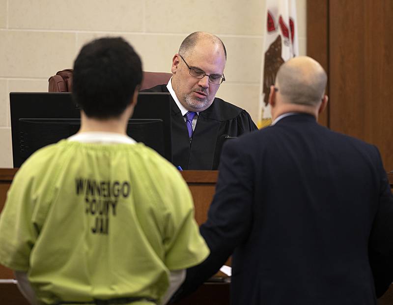 Jonathon Gounaris (left) stands before Judge Ben Roe in court Thursday, Feb. 6, 2025, in Ogle County.