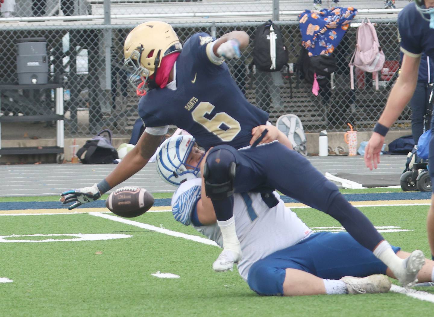 Princeton's Grady Cox knocks the ball loose from Central Catholic's Valshun Powe to recover a fumble durring the Class 3A playoffs on Saturday, Nov. 1, 2025 at Central Catholic High School in Bloomington.
