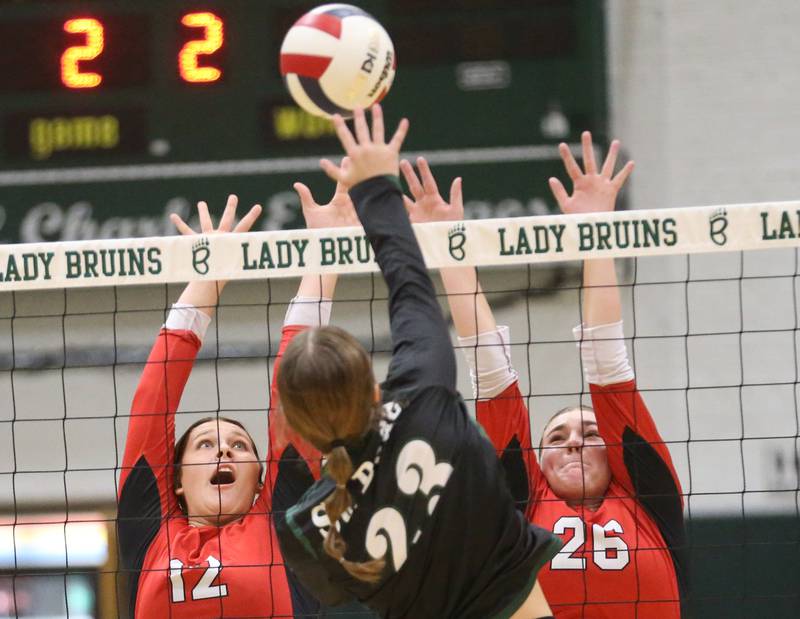 St. Bede's Mary Quinn McClain blasts the ball between Henry-Senachwine's Kaitlyn Anderson and teammate Brooklyn Thompson during the Class 1A Regional final game on Thursday, Oct. 31, 2024 at St. Bede Academy.