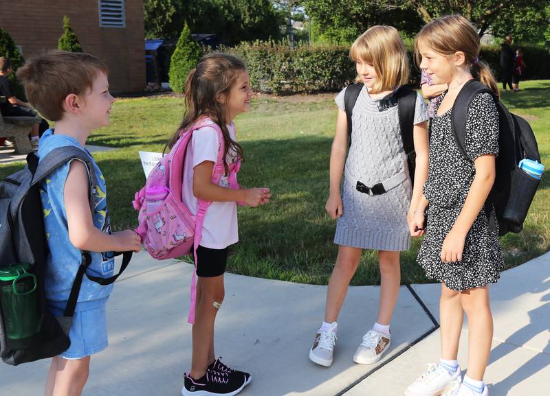 Landon Arand, Adrianna Marrufo, Bryn Arand and Haley Arand talk before the first day of school begins at Kaneland John Stewart Elementary in Elburn on Wednesday, Aug. 14, 2024.