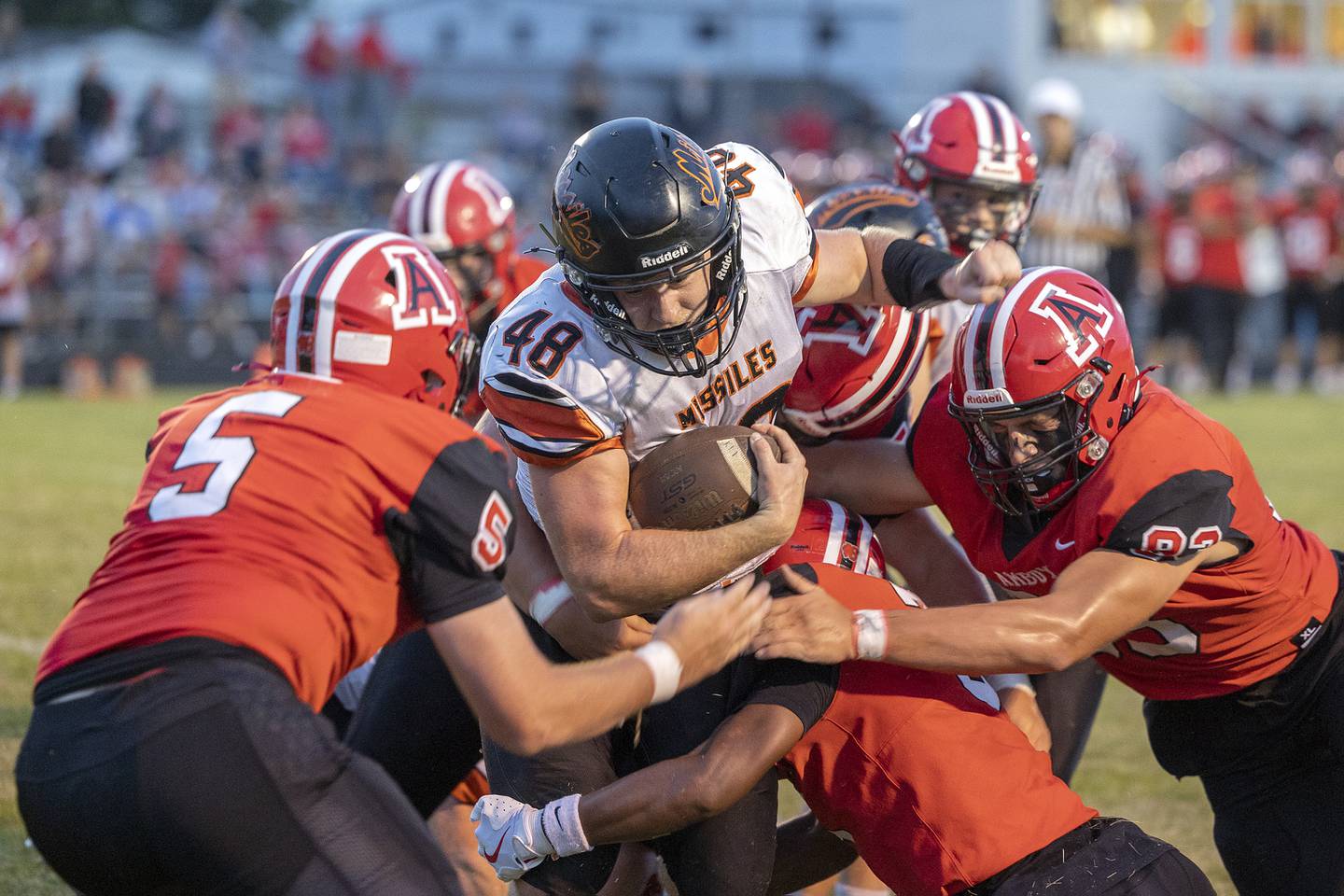 Milledgeville’s Karter Livengood fights through a host of Clippers against Amboy Friday, August 29, 2025, in Amboy.