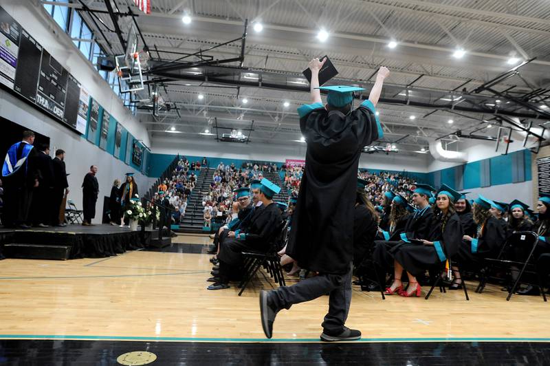 A graduate celebrates receiving his diploma Saturday, May 14, 2022, during the graduation ceremony at Woodstock North High School.