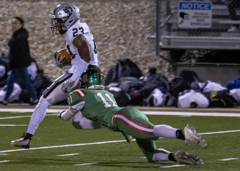 LaSalle Peru defensive back Kaleb Kennedy attempts to wrap up Kaneland's Aric Johnson after a completed deep pass during the game at Howard Fellows Stadium on October 20, 2023.