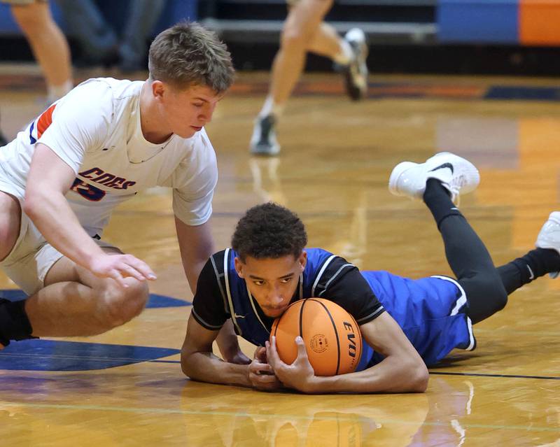 Hinckley-Big Rock's Emeka Ezuma dives for a loose ball in front of Genoa-Kingston's Conner Harney Tuesday, Jan. 6, 2026, during their game at Genoa-Kingston High School.
