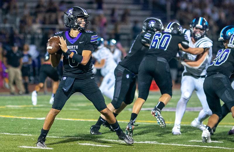 Downers Grove North's Sam Reichert (6) sits in the pocket and looks to pass downfield against Downers Grove South during a football game at Downers Grove North High School on Friday, Sep 9, 2022.