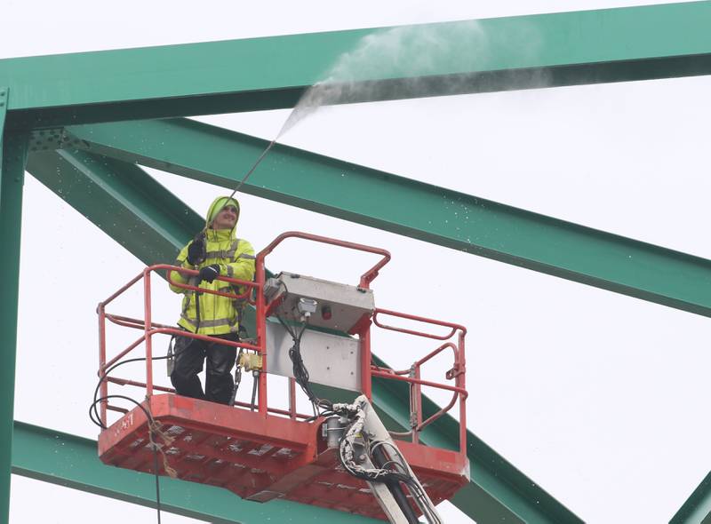 A Illinois Department of Transportation worker pressure washes the Illinois Route 251 bridge beams on Tuesday, April 16, 2024 in Peru. IDOT work will include washing the bridge and all of the structural steel, top surface of piers and abutments, deck drains and the deck surface. The work will be during the day, with traffic being reduced to one lane and controlled by flaggers. The project is scheduled to wrap up in early May.
