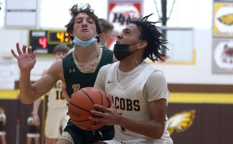 Jacobs’ Isiah Jackson, front, looks to the hoop during boys varsity basketball against Rockford Boylan at Algonquin Saturday afternoon. Boylan’s Luke Leombruni catches up on defense.