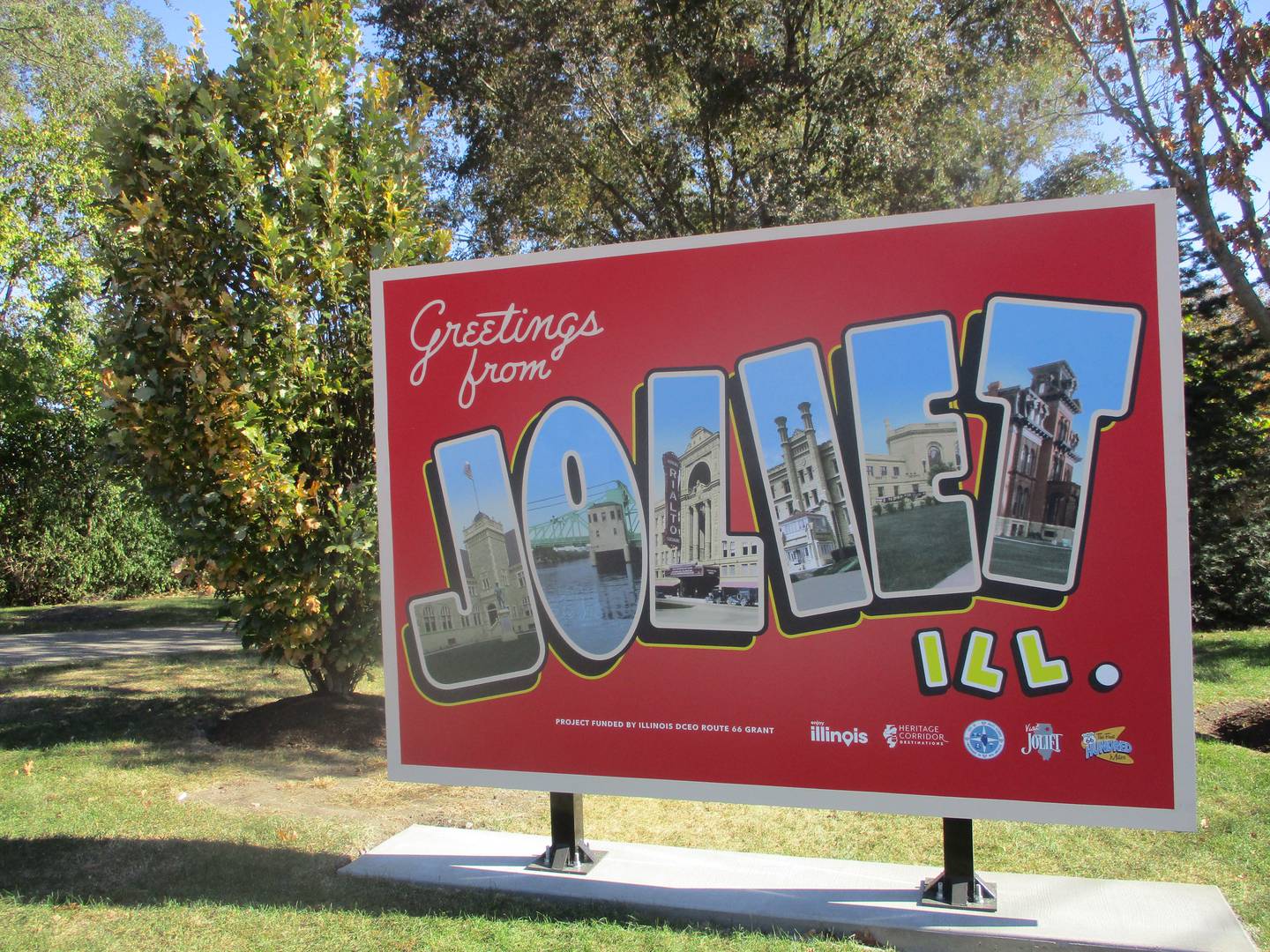 A sign replicating a postcard welcomes travelers to Joliet at the city's Route 66 Park. Oct. 23, 2024