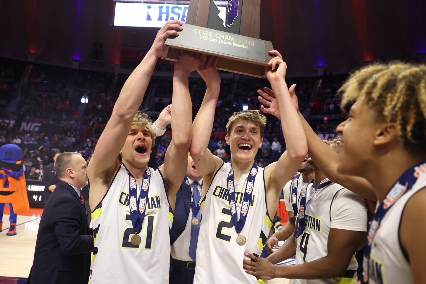 Yorkville Christian’s Elijah Fisher (21) and Jaden Schutt (2) hold up the championship trophy after their 54-41 win over Liberty in the Class 1A championship game at State Farm Center in Champaign. Friday, Mar. 11, 2022, in Champaign.
