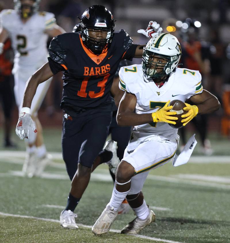 Waubonsie Valley's Tyler Threat is pursued by DeKalb’s Davon Grant during their game Friday, Sept. 29, 2023, at DeKalb High School.