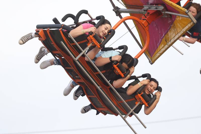 A group of friends ride the Cliff Hanger at Old Canal Days on Friday June 7, 2024 in Lockport.