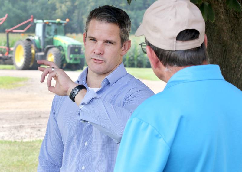 U.S. Rep. Adam Kinzinger, R-Channahon, (left) talks to farmer Bill Deutsch