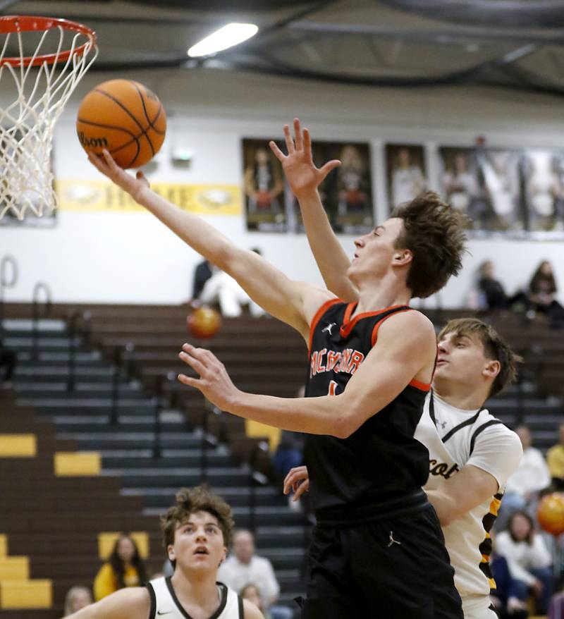 McHenry's Dylan Hurckes drives to the basket against Jacobs' Nolan Roper during a Fox Valley Conference basketball game on Friday, Jan. 24, 2025, at Jacobs' High School.