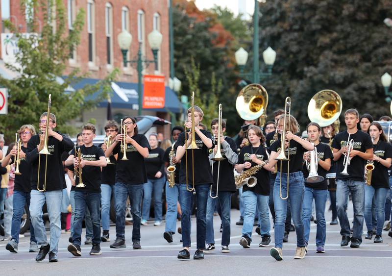 The Sycamore High School Marching Band makes its way through downtown Sycamore Wednesday, Oct. 5, 2022, during the school's homecoming parade.