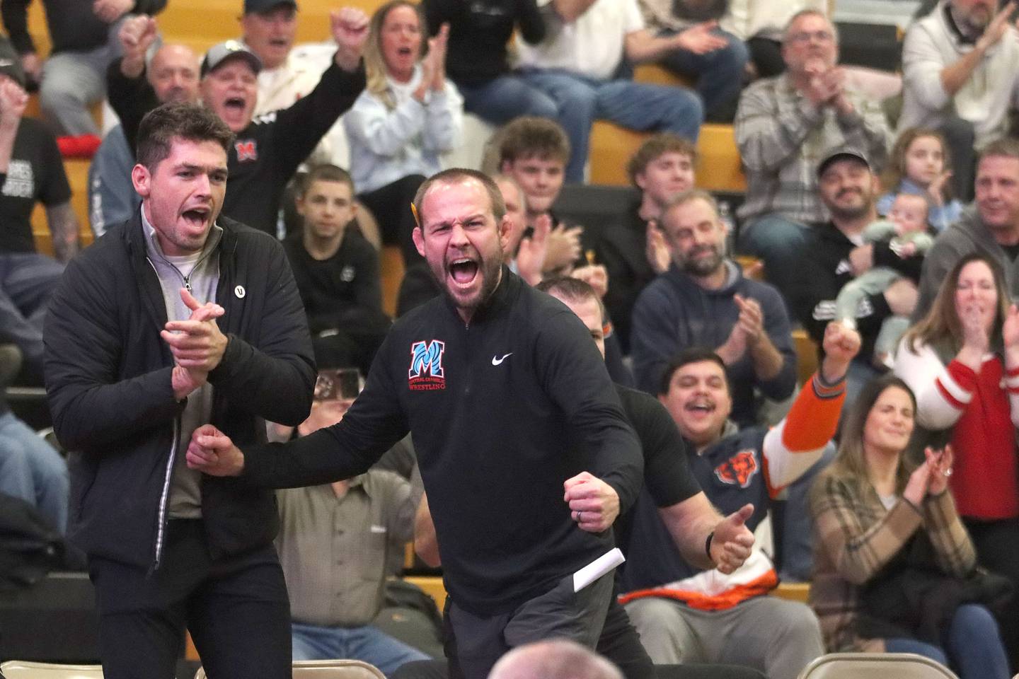 Marian’s coaches and fans celebrate a Dan French pin at 190 pounds against Washington in varsity boys wrestling on Thursday, Feb. 5, Marian’ Central coaches and fans celebrate a Dan French pin at 190 pounds against Washington in varsity boys wrestling on Thursday, Feb. 5, 2026, at Sycamore High School in Sycamore.2026, at Sycamore High School in Sycamore.