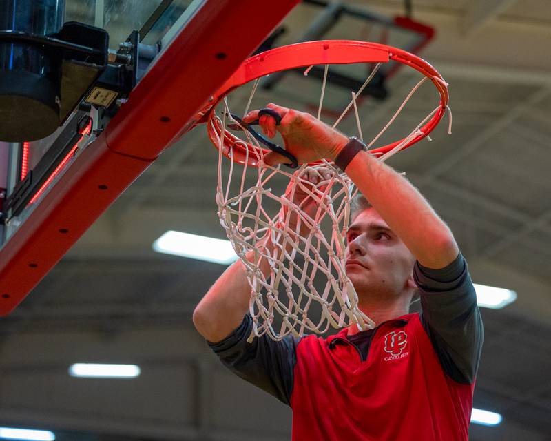 L-P maintenance worker cuts down net after Ottawa's Regional Championship Win over Sterling on Thursday, Feb. 19, 2026 in Sellett Gymnasium at L-P High School.