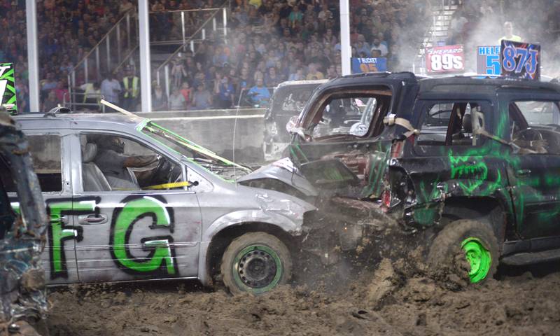 Cars collide in the mini van/SUV heat at the Whiteside County Fair's demolition derby on Saturday, Aug. 17, 2024.