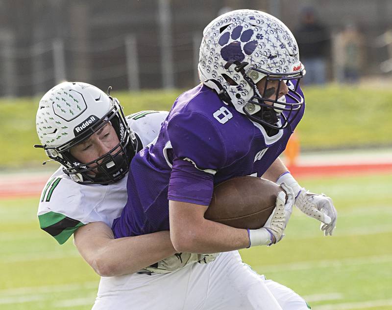 Wilmington's Kyle Farrell is stopped by Athens’ Grant Purchis Friday, Nov. 24, 2023 in the 2A state football championship game at Hancock Stadium in Normal.