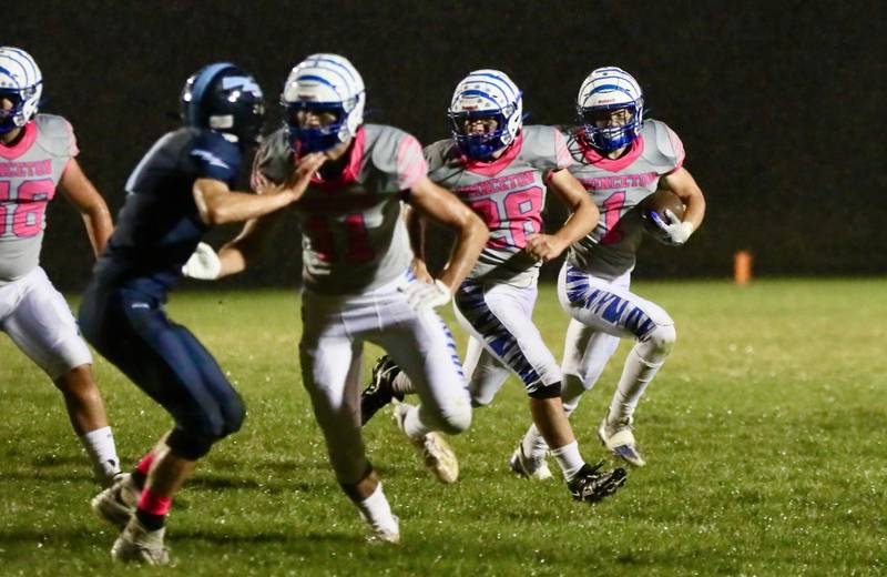 Princeton's Casey Etheridge runs behind teammates Noah LaPorte and Preston Arkels Friday night at Bureau Valley.