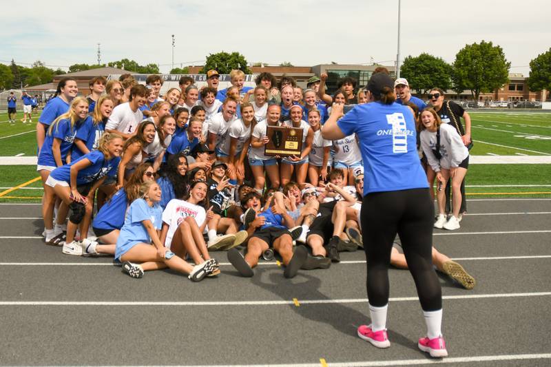 St. Charles North girls soccer team pose for a photo with the student section after receiving the sectional title plaque as they took the win over St. Charles North on Saturday May 27th held at West Chicago Community High School.