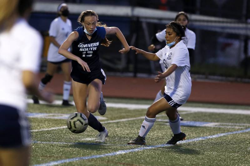 Downers Grove South’s Emily Petring (left) tries to get past Leyden’s Denisse Salgado during their soccer game at Downers Grove South High School in Downers Grove on Monday, May 17, 2021.