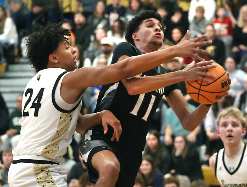 Kaneland's Evan Frieders grabs a rebound in front of Sycamore's Tyler Townsend during their game Friday, Jan. 9, 2025, at Sycamore High School.